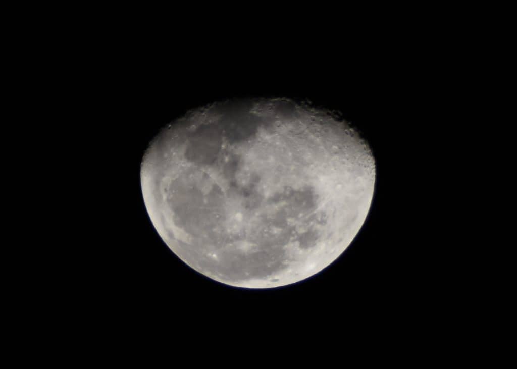 A correcly exposed photograph of the moon, where the surface details of the moon are visible, and the moon doesn’t look dimmed or shadowy.